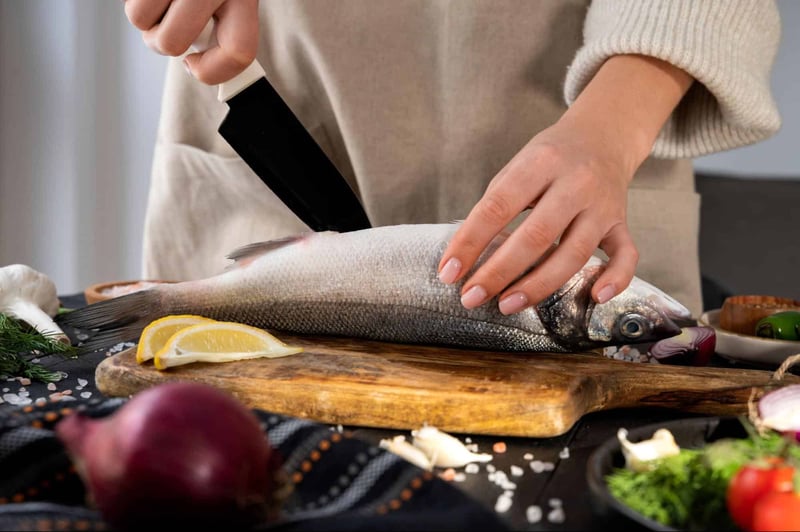 Fresh fish being prepared with lemon slices for a nutritious dog meal, emphasizing healthy and natural pet food options.
