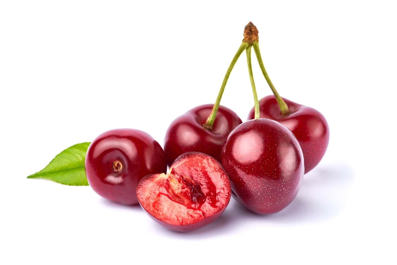 Fresh red cherries with green leaf on white background.