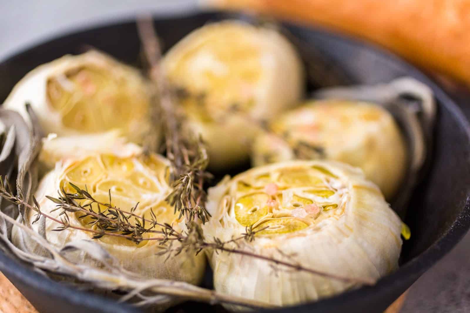Fresh roasted garlic with herbs and spices, perfect for cooking or pet-friendly recipes.