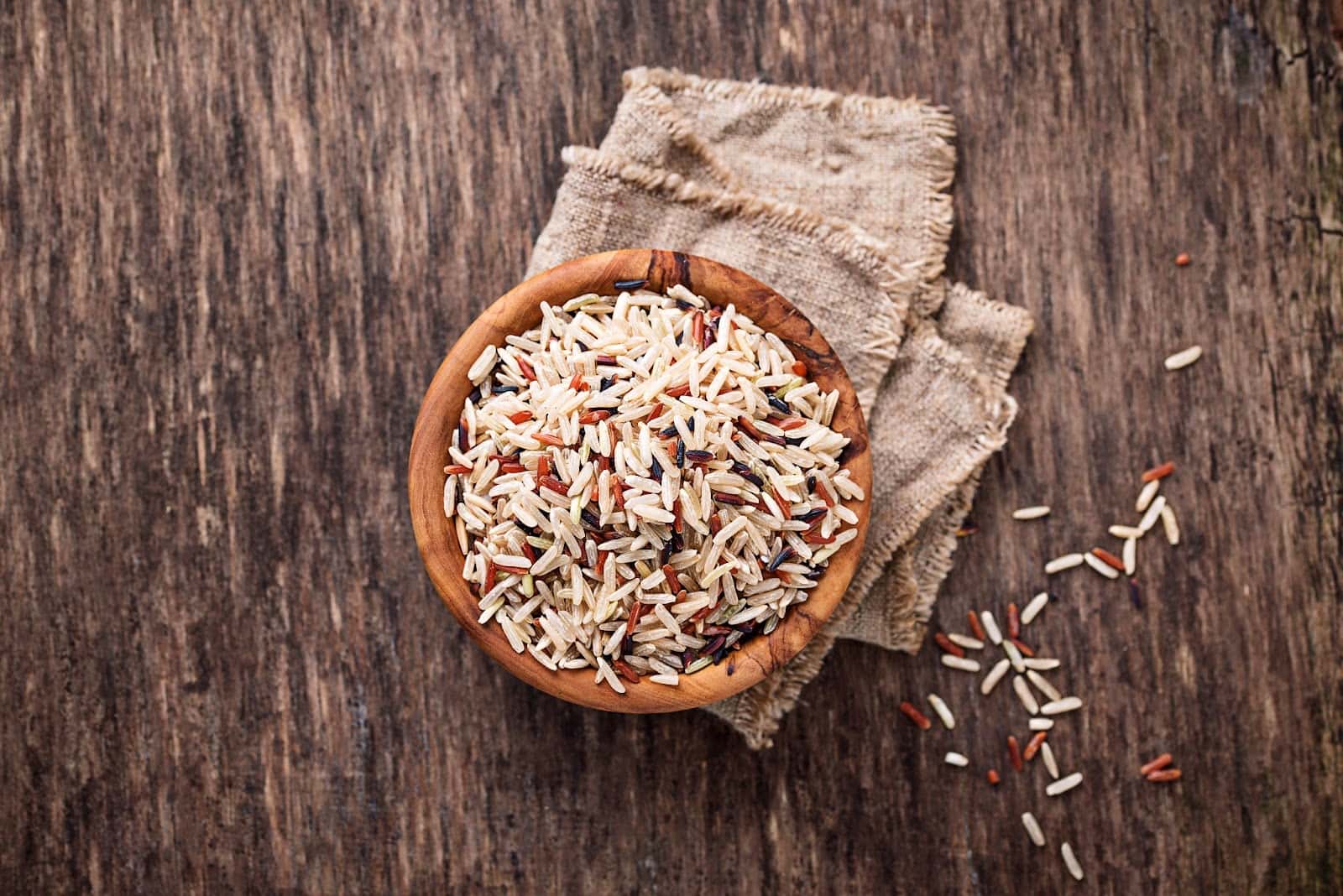 Healthy pet rice food in wooden bowl on rustic table, natural dog nutrition.