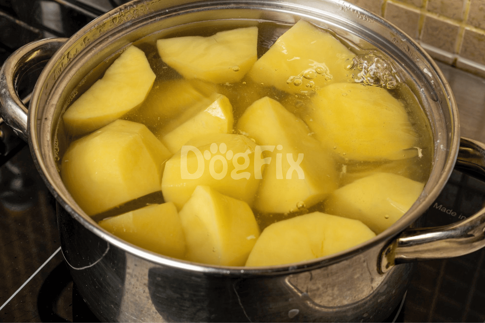 Image of chopped potatoes boiling in a pot, prepared as a healthy dog food ingredient.