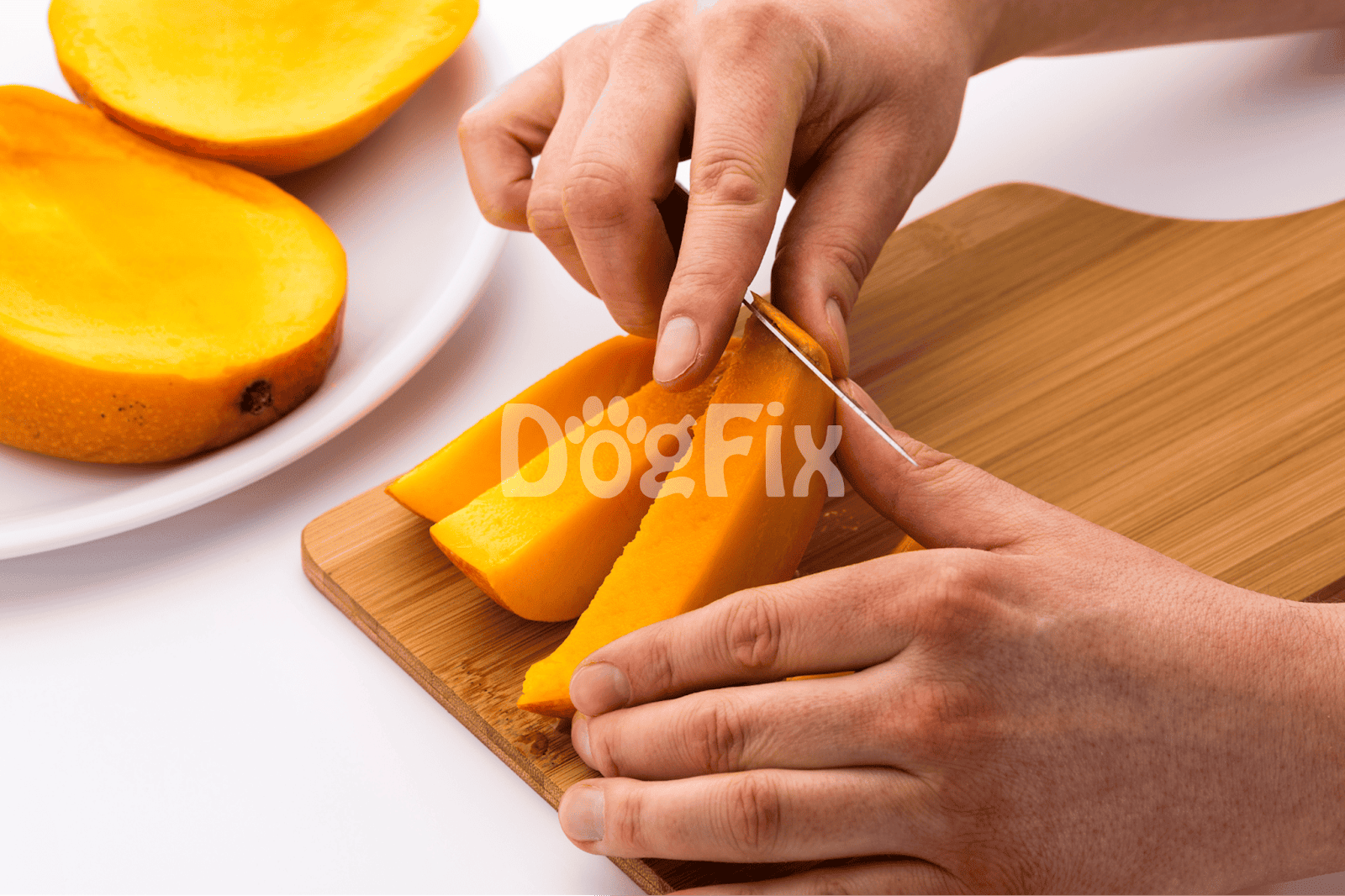 Image of hands slicing ripe mango on a wooden board with mango pieces in the background.