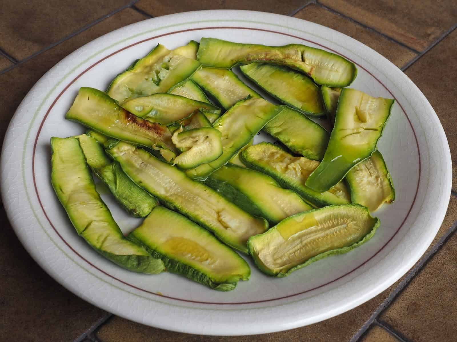 Healthy roasted green bell peppers served on a white plate.