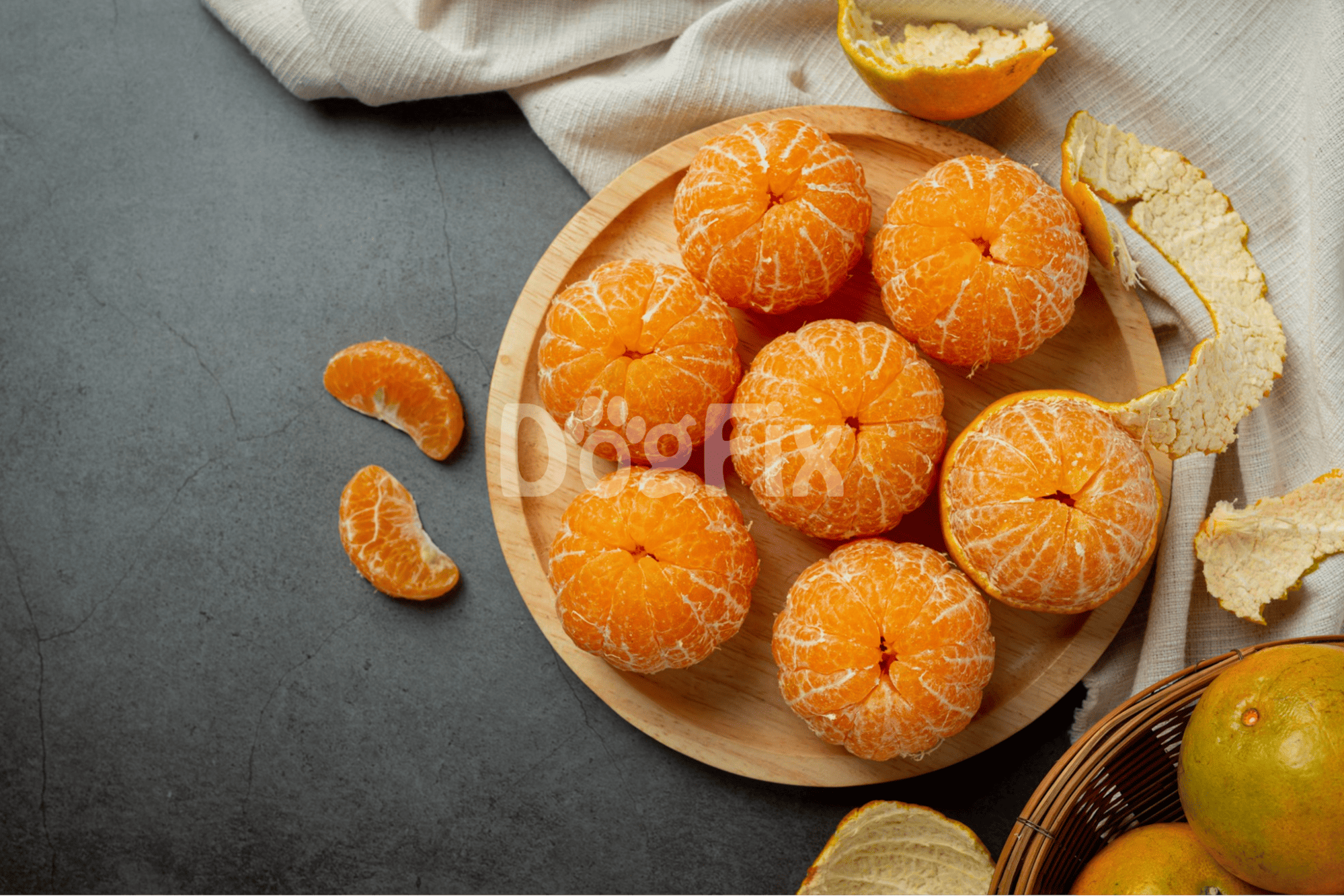 Juicy mandarin oranges with peels on a rustic grey background for healthy eating.