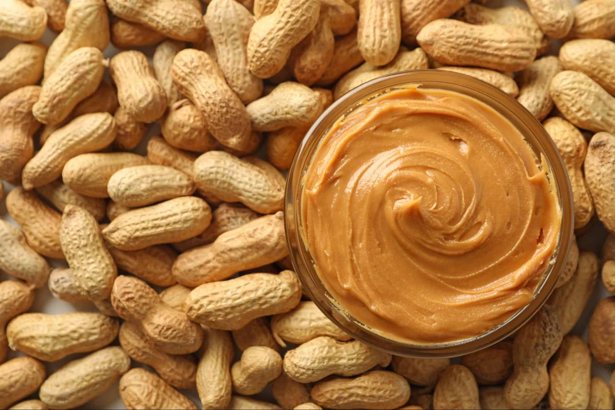 Delicious peanut butter spread over peanuts, perfect for dog treats and healthy snacks.