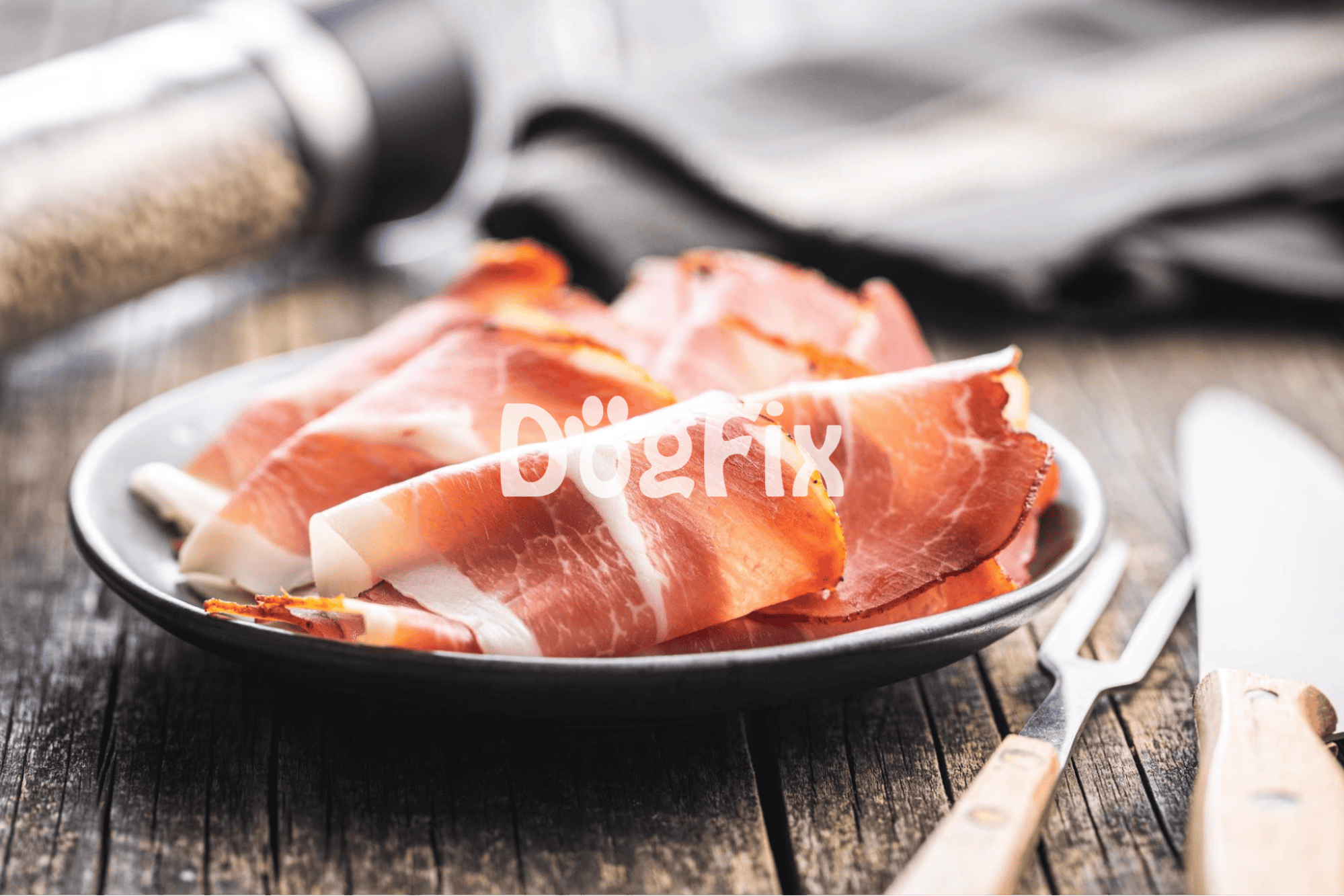 Delicious thinly sliced prosciutto served on a dark plate, ideal for dog treats or gourmet dining.