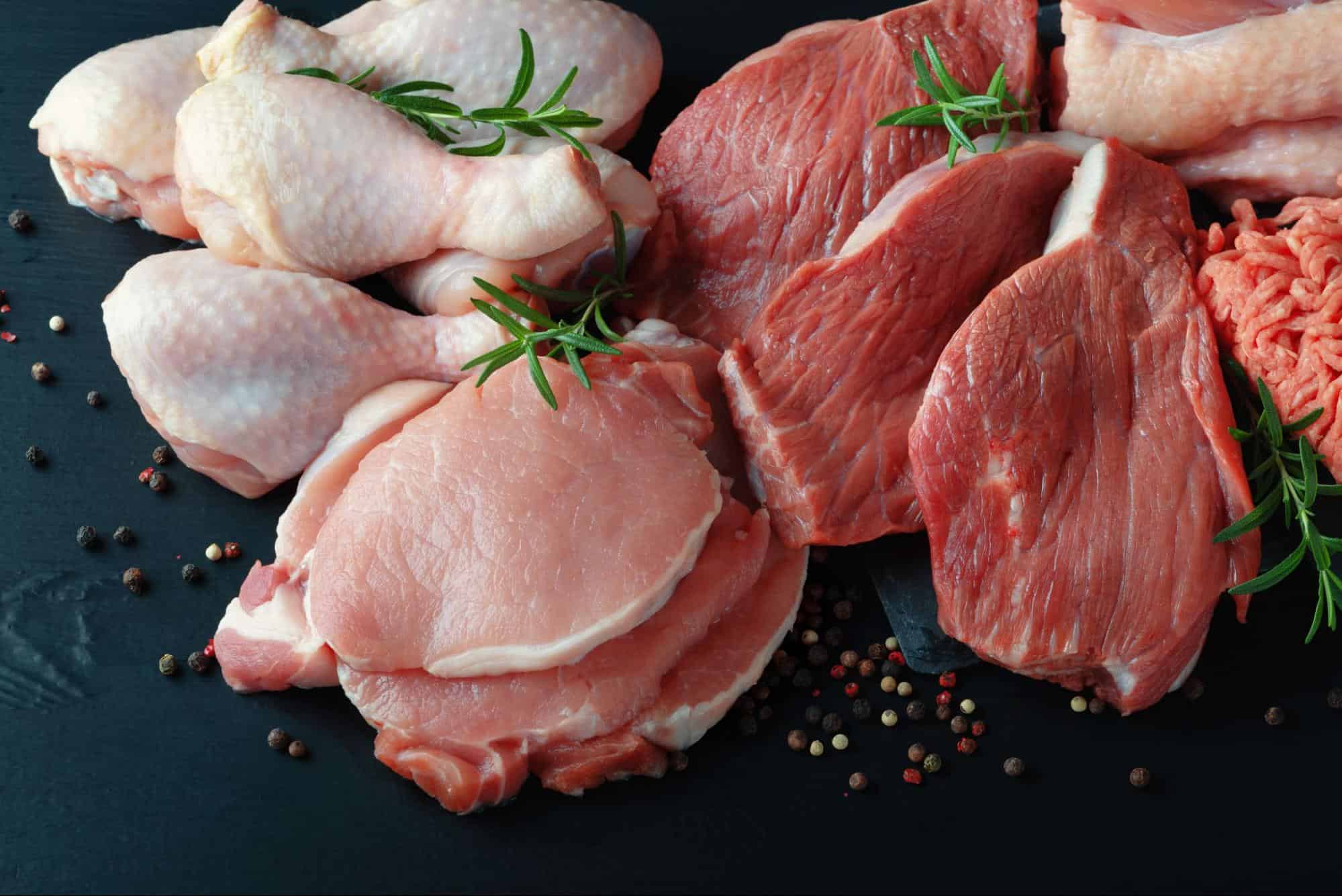 Fresh raw chicken and beef with herbs and spices, ideal for nutritious dog diets.