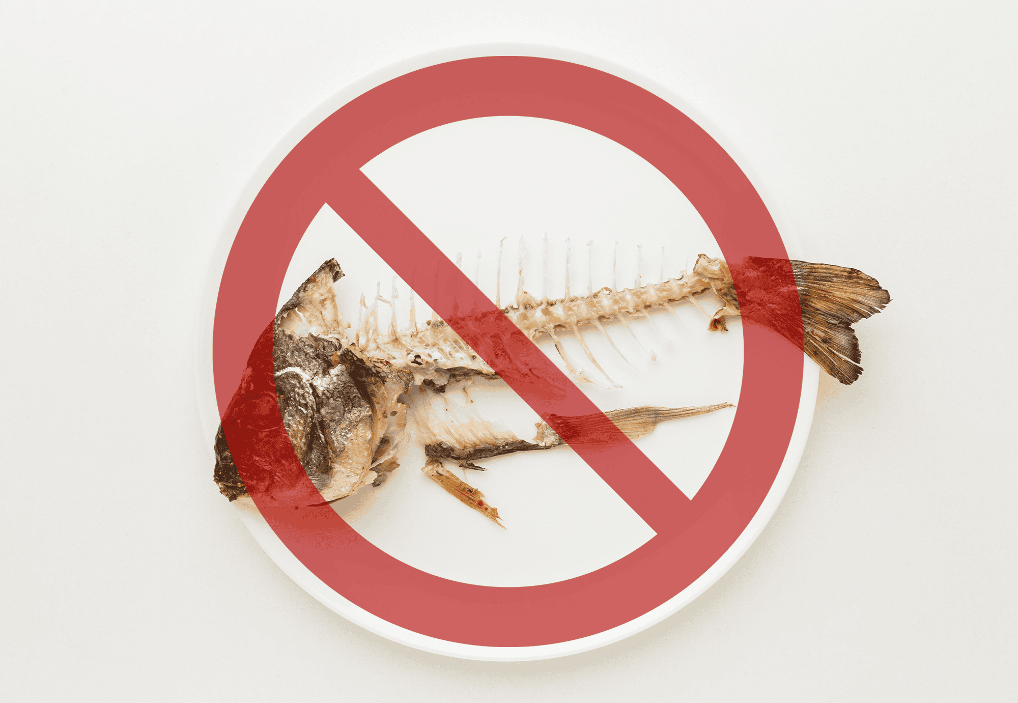 Fish bones on a plate with 'no' symbol overlay.