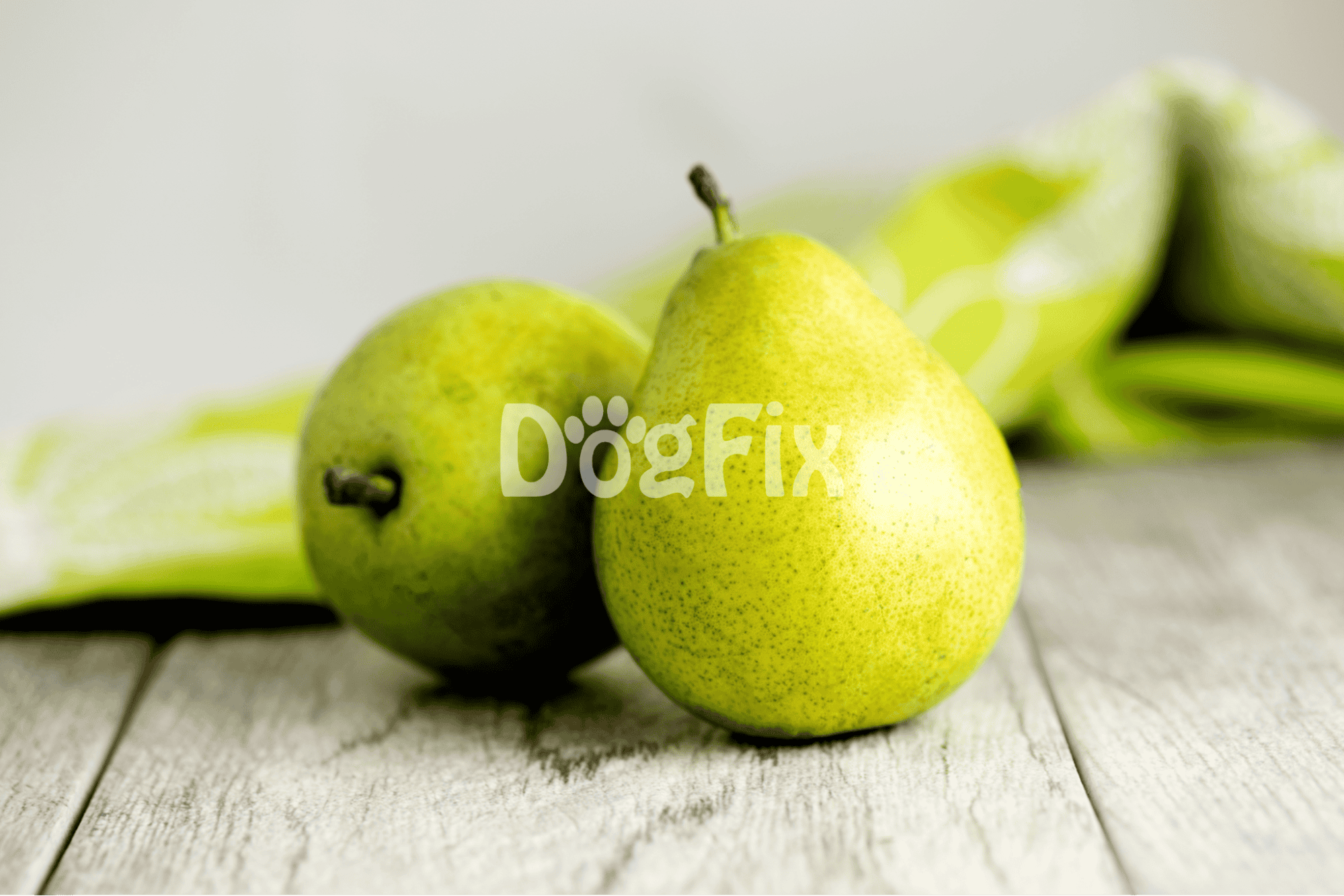Fresh green pears on rustic wood with blurred background emphasizing healthy dog treats.