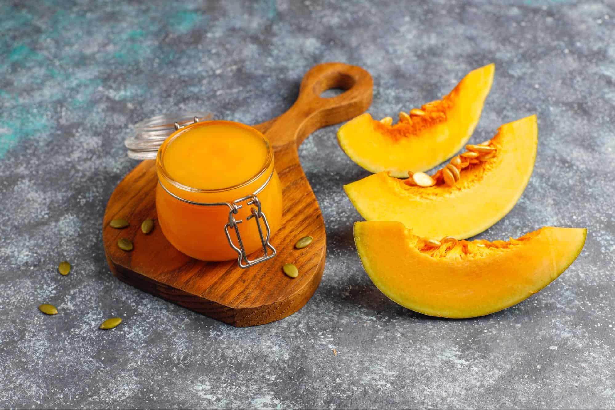 Fresh butternut squash slices and vibrant pumpkin puree for healthy dog snacks.