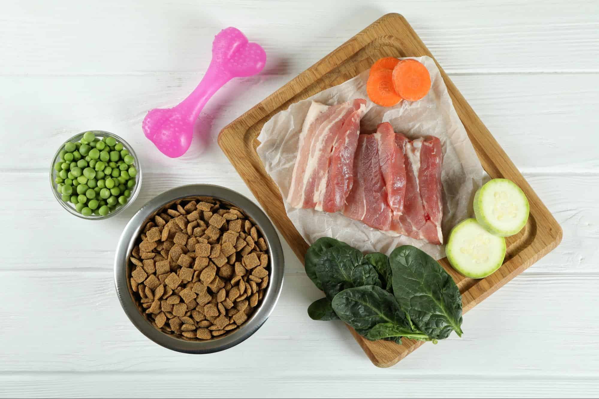 Fresh meat, vegetables, and kibble for dogs.