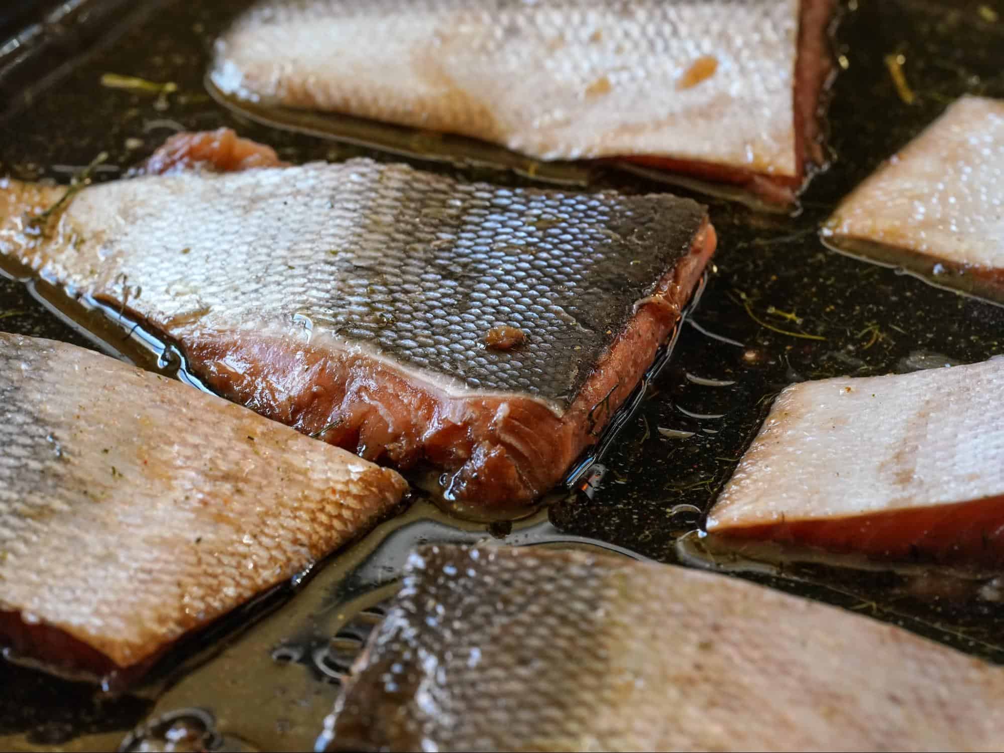 Delicious fish fillets cooking in hot oil, crispy skin and tender meat perfect for a healthy diet.