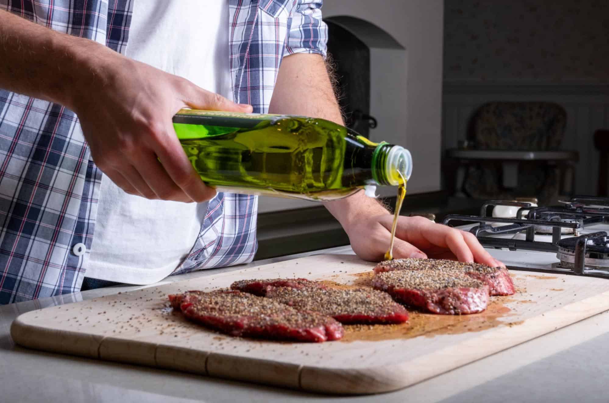 Clean cooking of steak with oil in kitchen for pet nutrition tips.