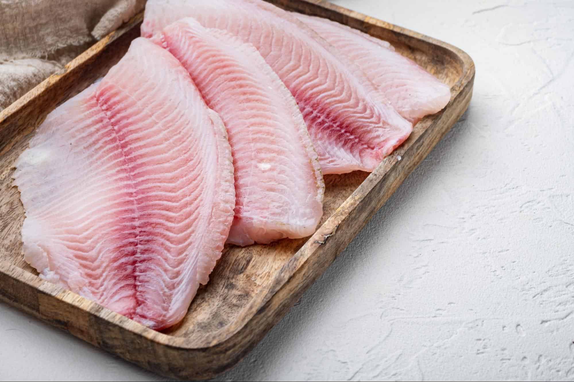 Raw fish pet food, fresh fish fillets for dogs' healthy diet and bone health.