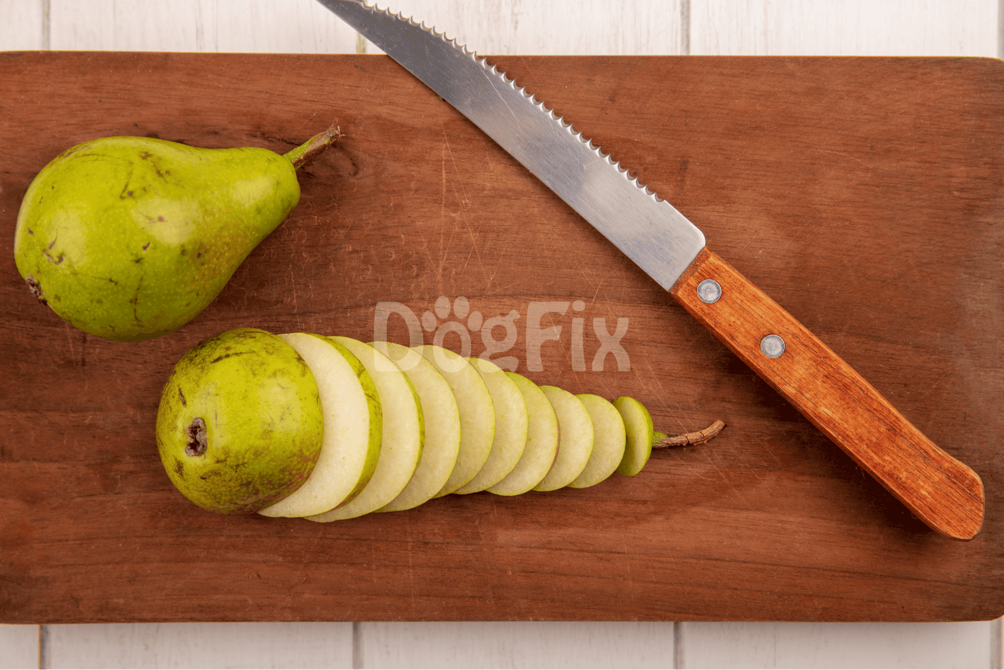 Pear sliced on wooden cutting board with a sharp knife, fresh fruit for healthy snacks or recipes.
