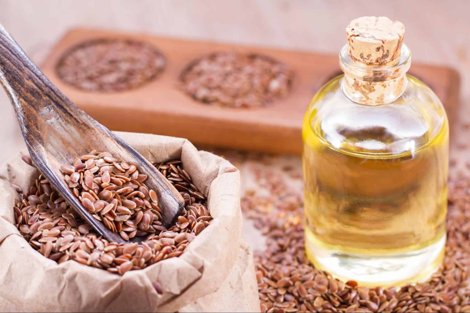 Alt: Bottle of flaxseed oil and flaxseeds for canine health benefits and nutrition.