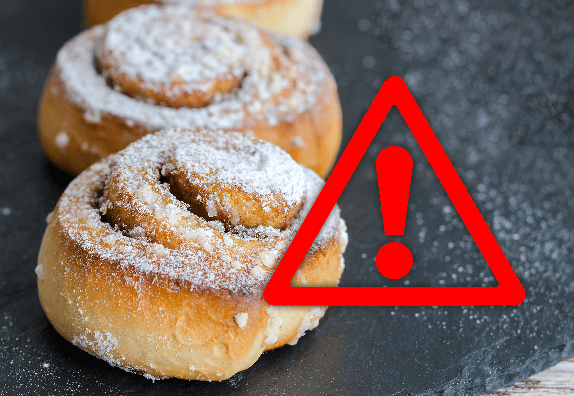 Delicious cinnamon rolls dusted with powdered sugar, caution for high sugar content or allergens.