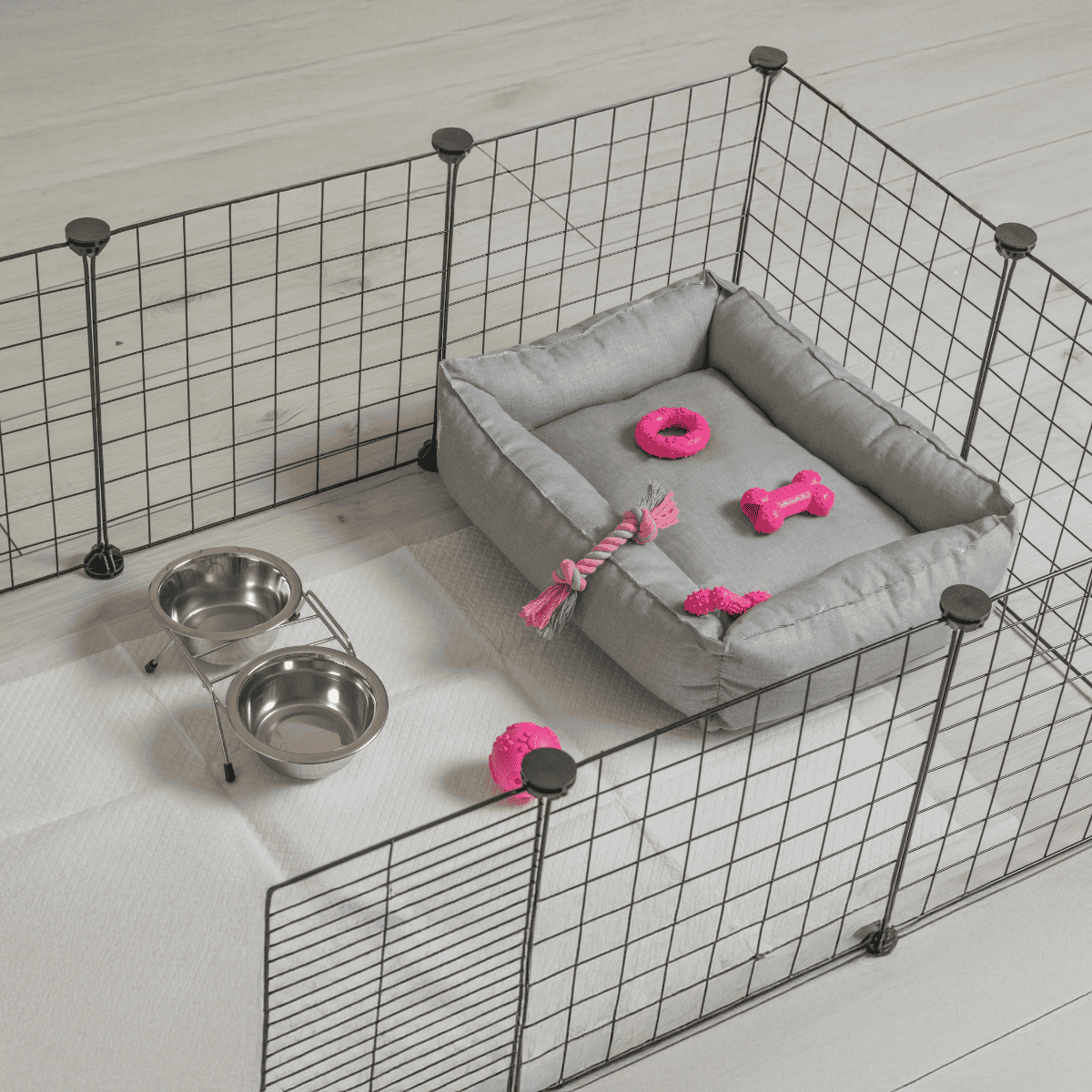 Crate for small dogs with bed, toys, and water bowls inside playpen.