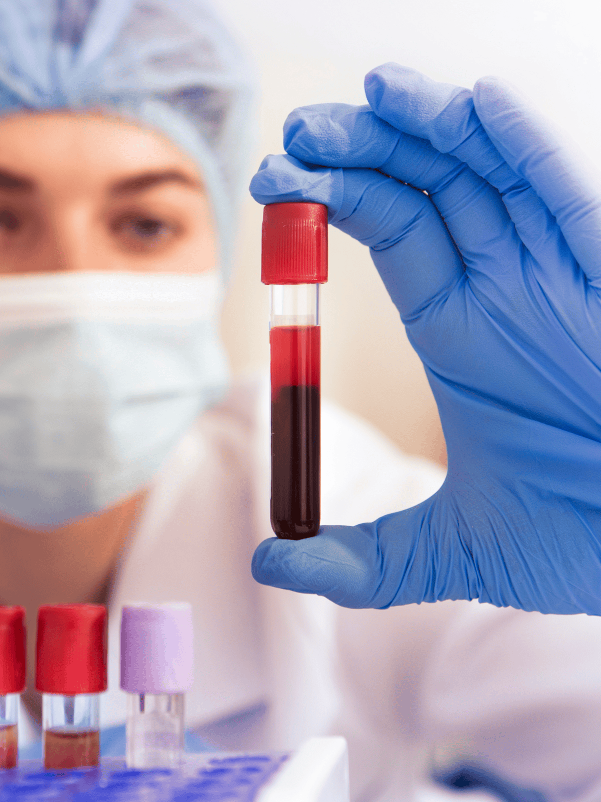 Medical professional holding a blood sample in a test tube, laboratory setting, healthcare, diagnostics.