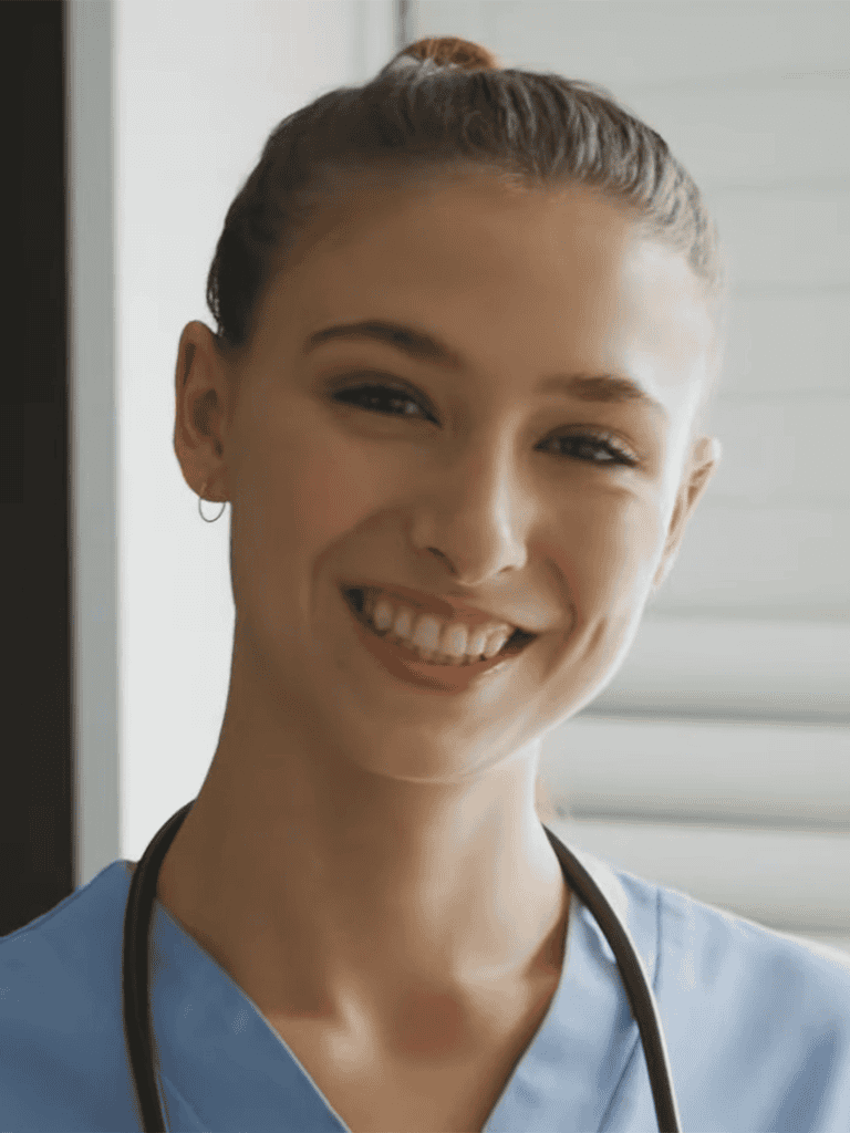 Vet smiling in scrubs with stethoscope.