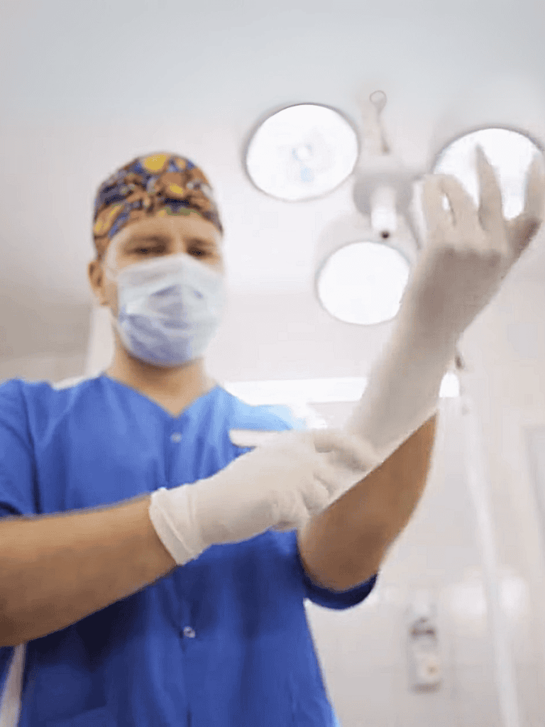 Dental vet performing oral cleaning on dog with surgical tools.