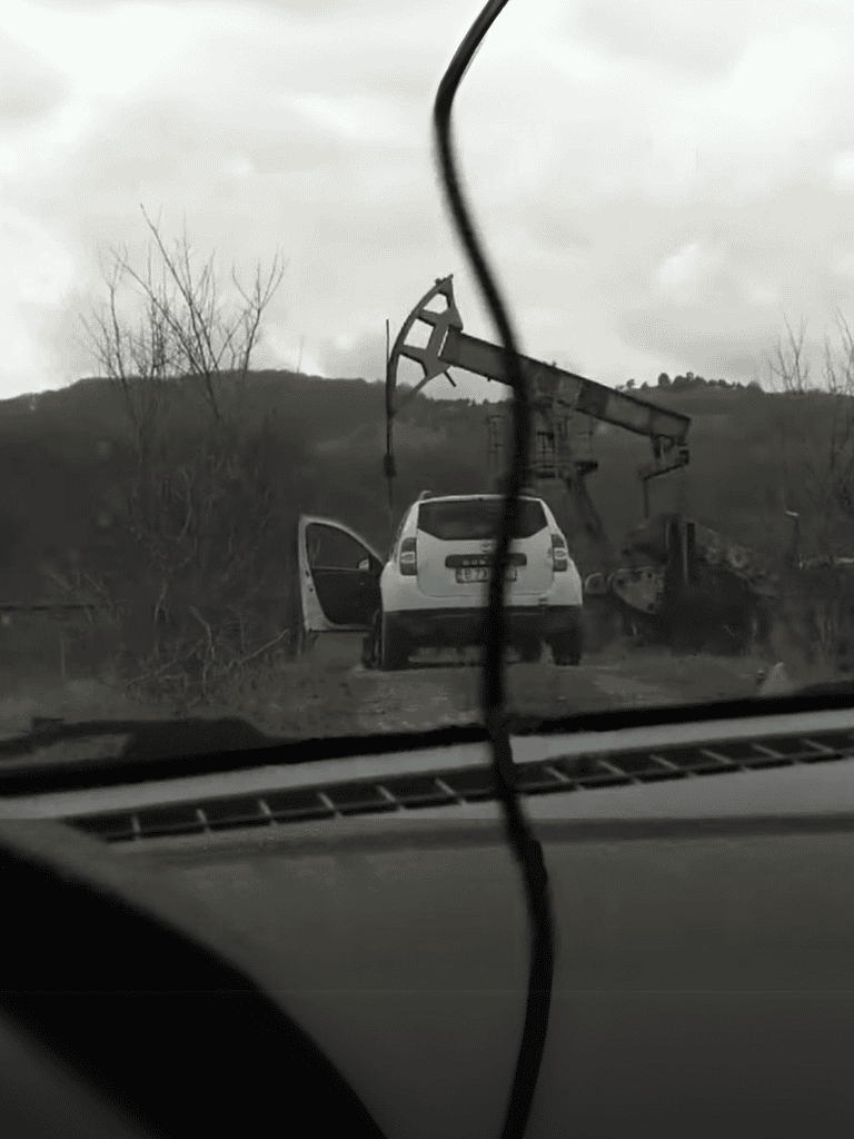Oil rig falling over during storm captured from vehicle.
