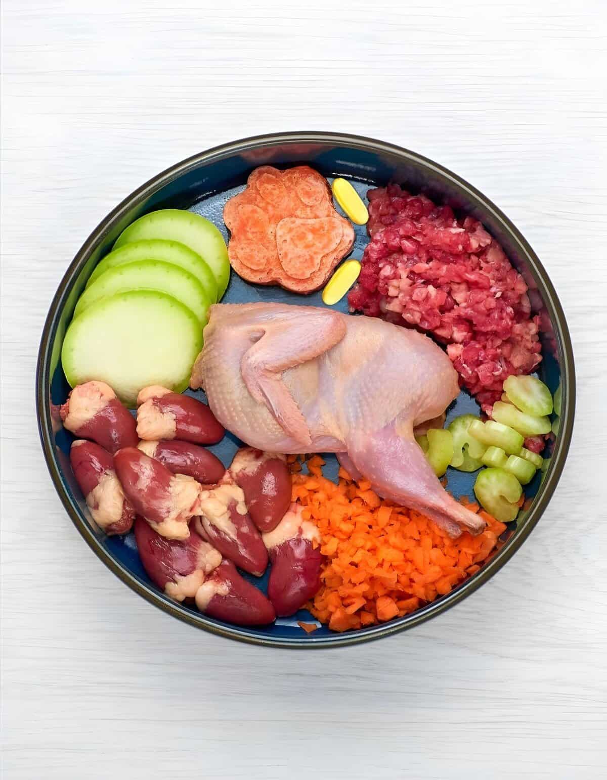 Healthy dog food with vegetables and proteins in a blue bowl, promoting pet wellness.