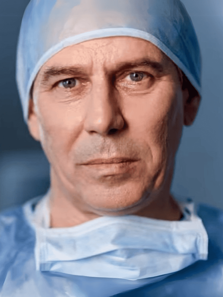 High-quality image of a male surgeon in medical scrubs and surgical cap, ready for operation.