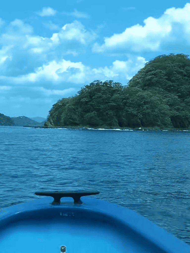 Tranquil water scene featuring lush green islands and a bright blue sky, perfect for outdoor adventure lovers.