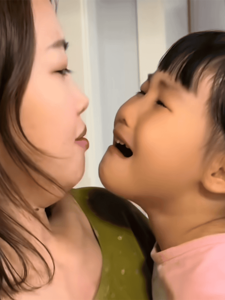 Close-up of mother and young boy smiling at each other with love and affection.