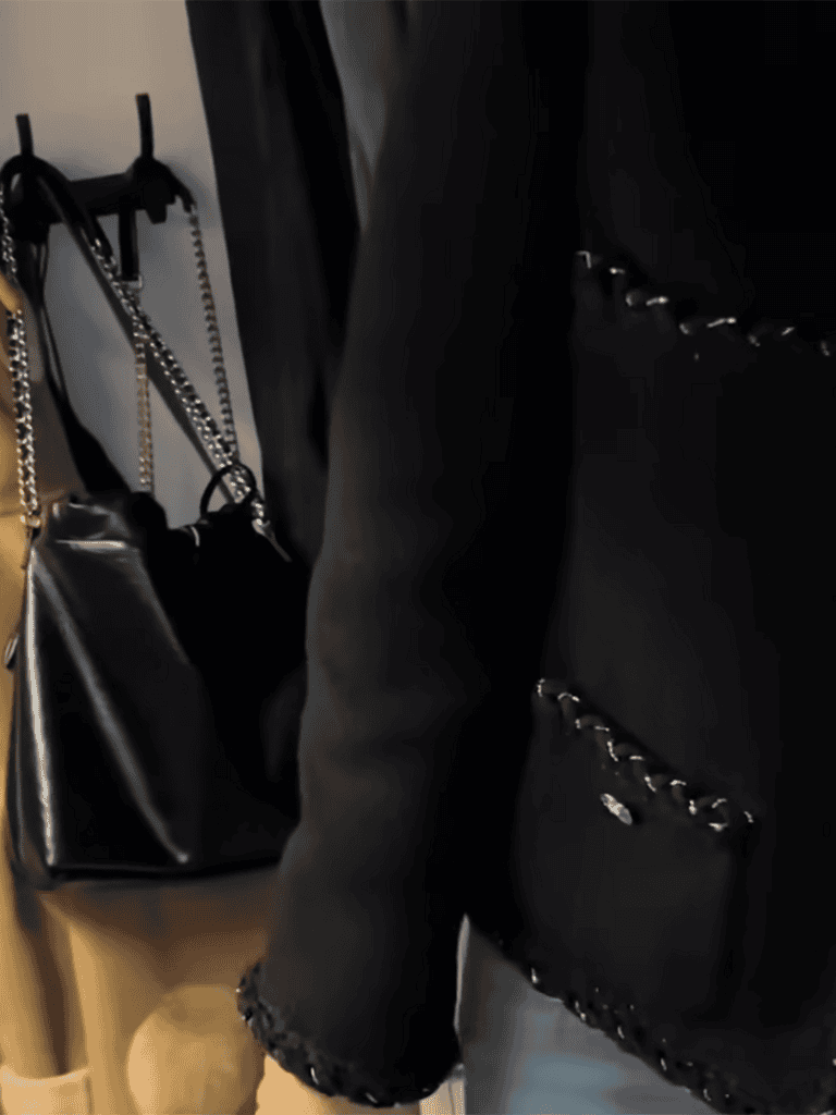 Elegant black purse with chain shoulder strap for stylish outings.